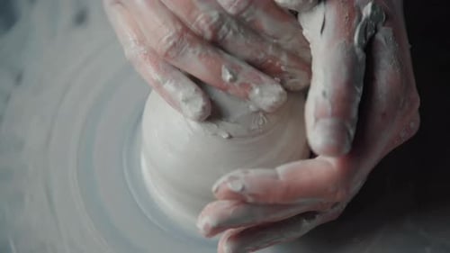 Hands Forming Clay on Pottery Wheel