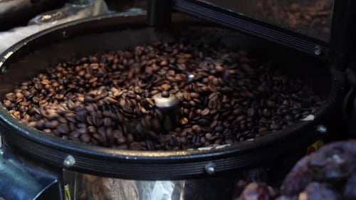 Roasted Coffee Beans Turning in Roasting Machine