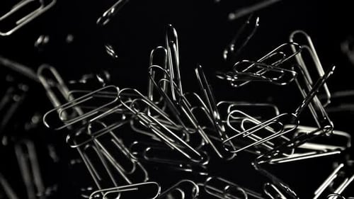 Shiny Metal Paperclips Against a Dark Background