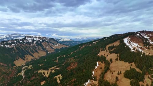 Thick grey cloudscape hanging over the mountain tops