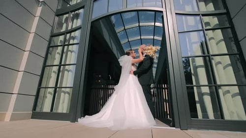 Happy Couple Embrace in Urban Wedding Setting