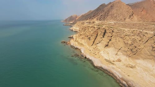 Rock Formations Along Seaside Cliffs with Ocean Waves Crashing