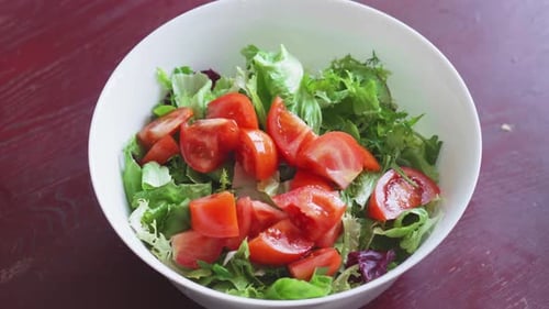 Vibrant Lettuce and Tomato Salad in White Bowl