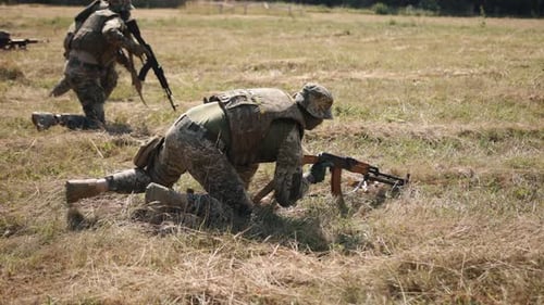 Military Training Exercise in Grassy Rural Field