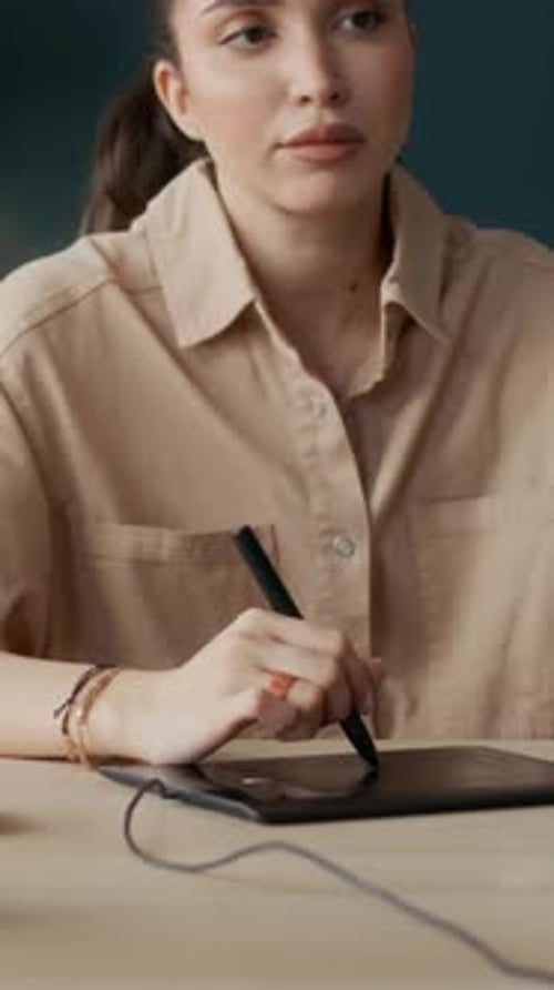 Graphic Designer Using Digital Tablet at Desk Indoors