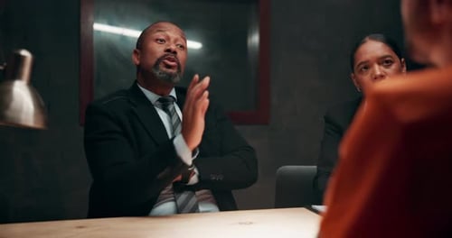 Police, criminal and discussion in interrogation room for investigation, legal question or arrest