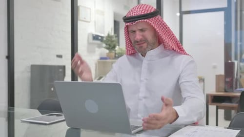 Frustrated Man Working at Desk With Laptop