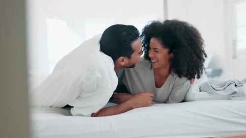 Loving Couple Cuddling and Laughing in Bed