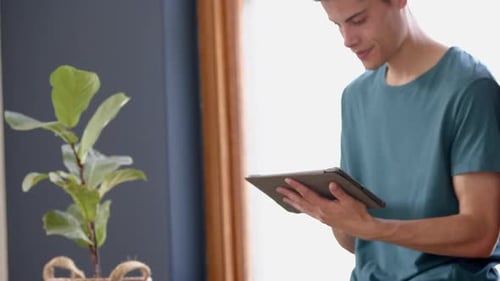 Young Adult Using Tablet Indoors