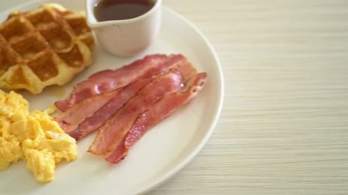 Classic American Breakfast with Bacon, Eggs, and Waffle