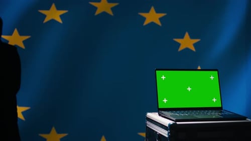 Laptop with Green Screen in Front of EU Flag