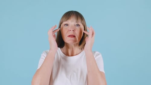Mature Woman Demonstrates Facial Exercises