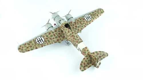 Rotating Camouflage Model Airplane Against White Background