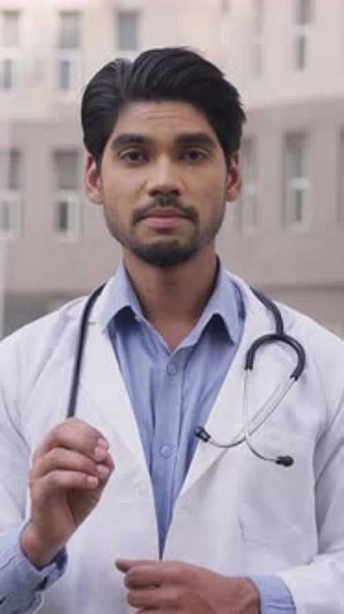 Young Doctor Explaining a Medical Issue Outside