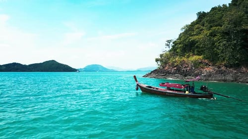 Drone Shot of a Sailboat Anchored in a Stunning Turquoise Lagoon