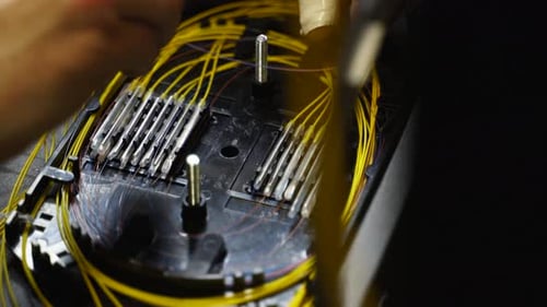 Worker Welds Optical Line Internet Wire with Welding Machine Service Man Soldering Optical Fiber