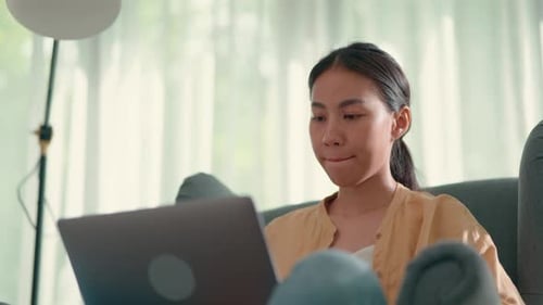 Woman Working on Laptop in Comfortable Home