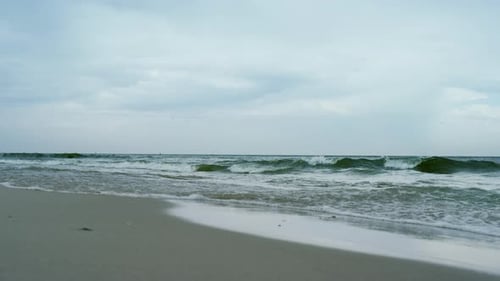 Waves Crashing Sandy Beach On Grey Cloudy Weather. Aerial View Ocean Storming On Seashore In Lone...
