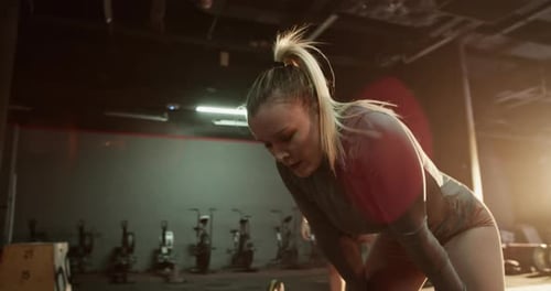 Sportswoman Taking Break After Intense Workout at Gym