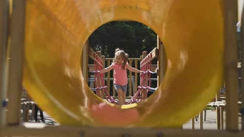 Adorable Child Having Fun Playing on Playground Equipment