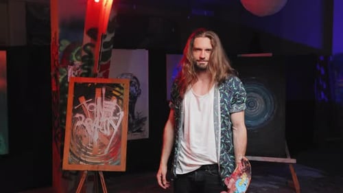 Talented Artist Standing Next to Easel in Creative Art Space