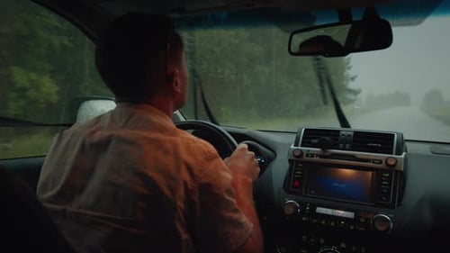 Limited Visibility Driving Man Steers the Car on a Narrow Rural Road During Heavy Rain Shower with