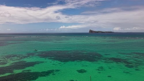 Aerial Drone View of Catamarans and Yachts Anchored in a Calm Turquoise Ocean Near a Remote Island