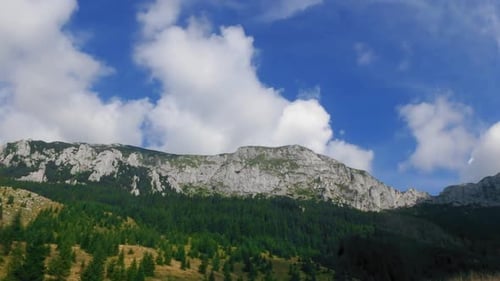 Timelapse of clouds passing over a mountain ridge