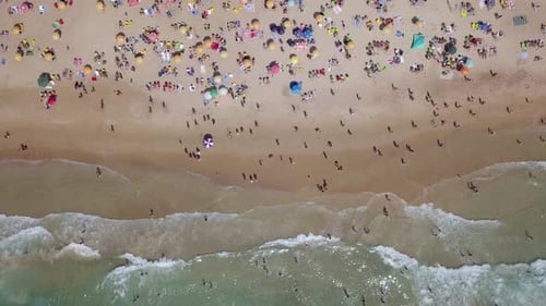 Mediterranean beach during summer with people in the water