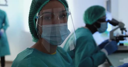 Medical Professionals in Protective Gear in Laboratory Setting