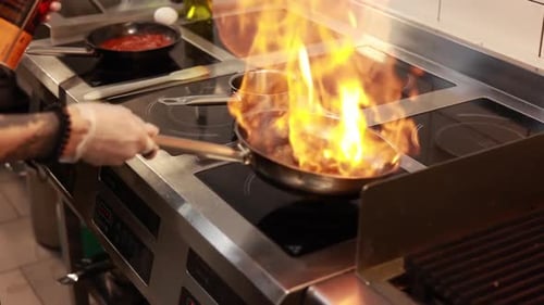 Chef Cooking With Flames on Stovetop