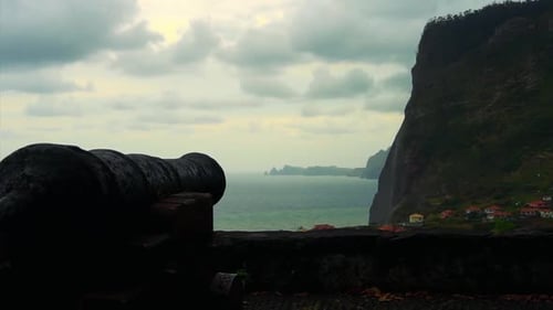 Footage of a canon pointing to the landscape on the horizon.