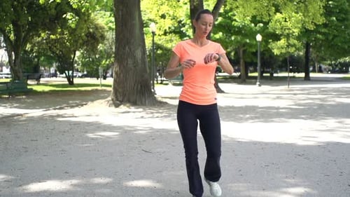 Woman Checking Pulse on Smartwatch After Jogging in City Park, Super Slow