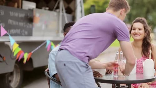 Friends Enjoying Drinks and Food from Food Truck