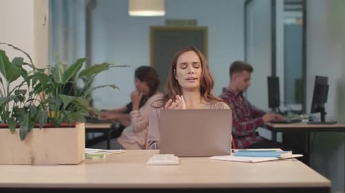Business Woman Trying to Relax at Coworking. Pretty Woman Stretching Herself After