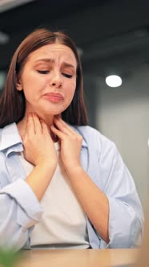 Young Woman Experiencing Throat Pain Indoors