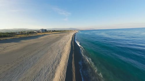 Slow Flight On The Sandy Beach with Calm Ocean