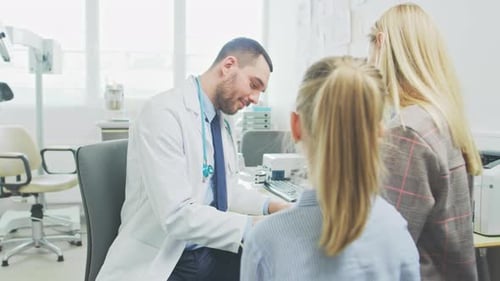 Doctor consults with child and mother in office
