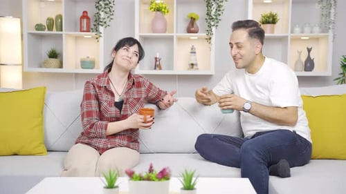 Cheerful Couple Conversing on Couch in Modern Home