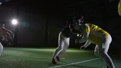 American Football Players Grappling on Scrimmage Line during Training