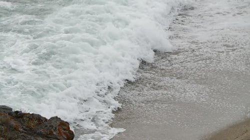 Waves Crashing on a Sandy Beach Shoreline