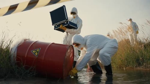 Scientists in Hazmat Suits Examine Toxic Waste