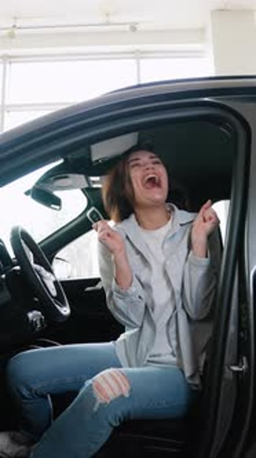 Happy Woman Customer is Showing Key of Her New Car Looking at Camera and Smiling Vertical Video