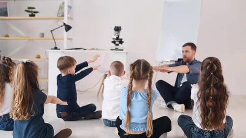 Doing gestures, learning how to spoke something. Group of children students in class at school