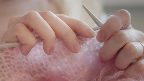 Detailed View of Knitting Needles and Fluffy Yarn