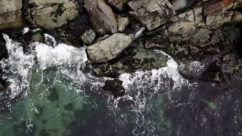 Waves Crashing on a Rocky Shoreline from Above