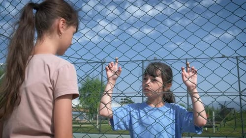 Fenced Stressed Children on Playground