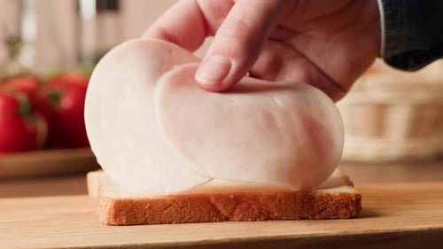 Close Up of Sandwich Preparation with Ham Slice
