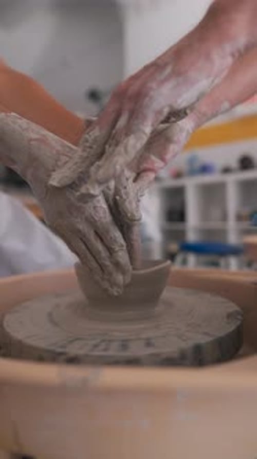 Creating Unique Art By Shaping Clay on a Pottery Wheel Inside a Creative Studio Environment