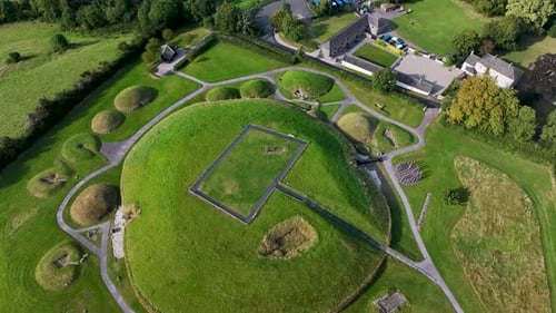 Beautiful drone view of Neolithic monument Knowth in Ireland. Green mounds and tombs.